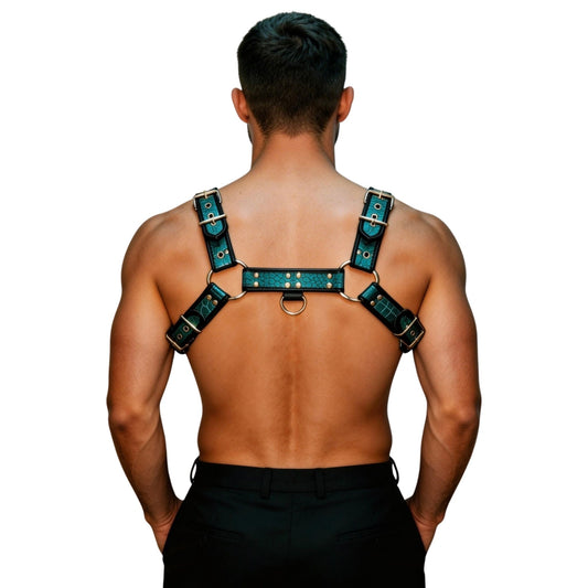 Man wearing a aqua crocodile harness with gold accents on a white background