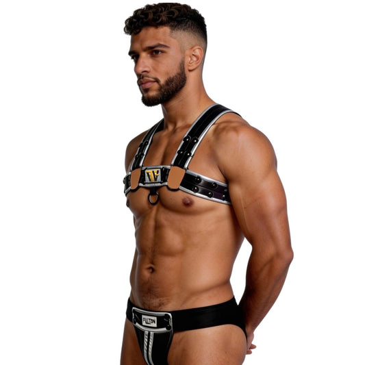 Man wearing a black harness with visible branding on a white background side view