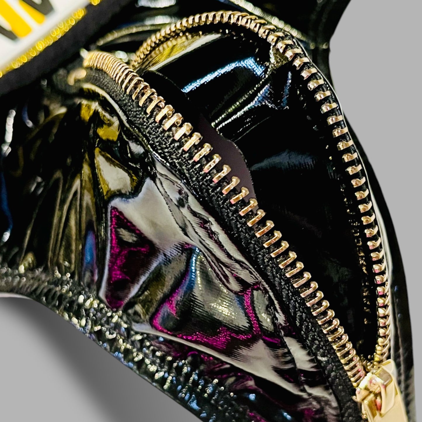 close up detail shot of a gold zipper on black leather underwear