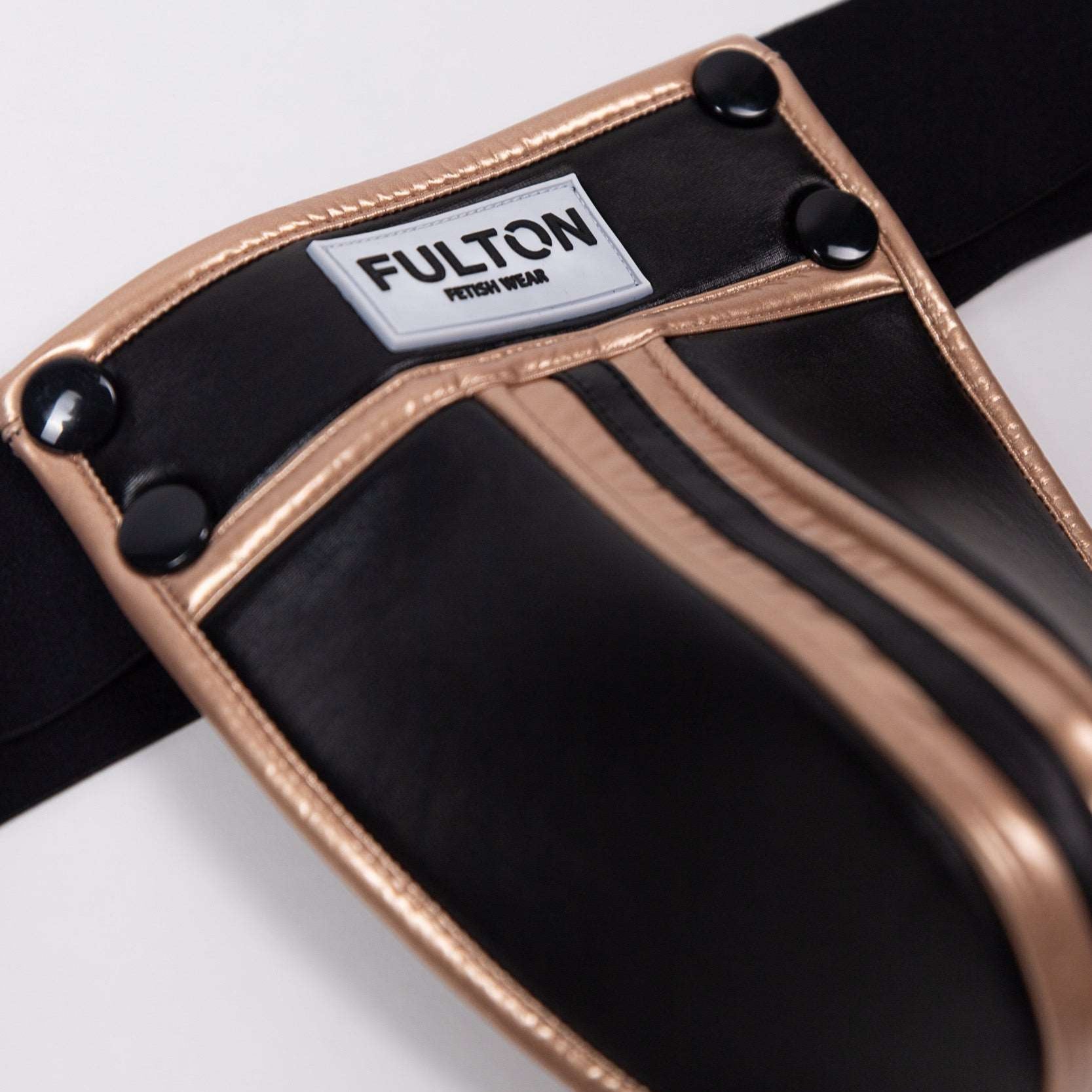Second Close-up detail of gold metallic trim and black faux leather construction on jockstrap