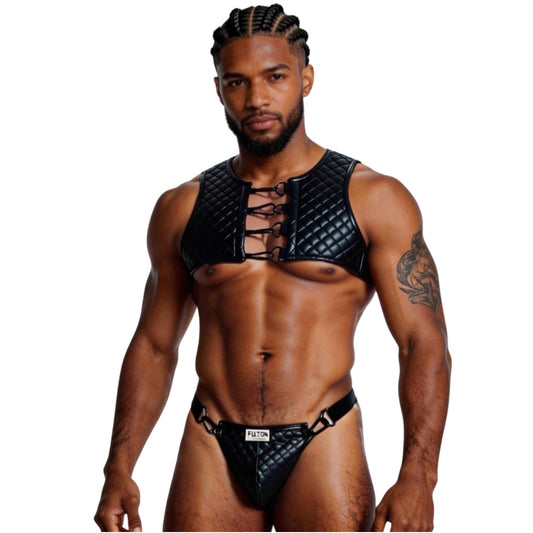 Man wearing a black leather harness and underwear set on a white background