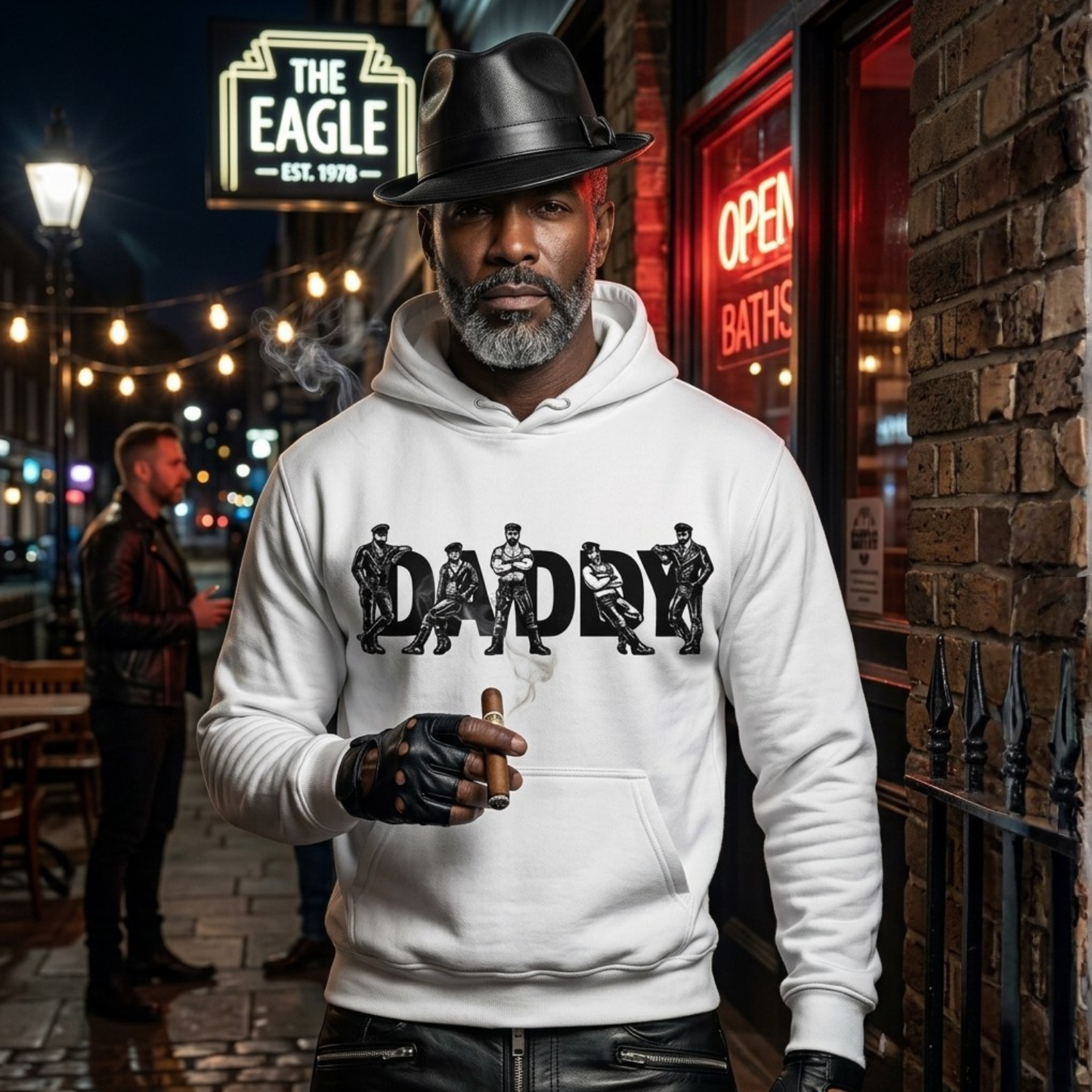 Man wearing a white hoodie with 'DADDY' graphic in an urban setting