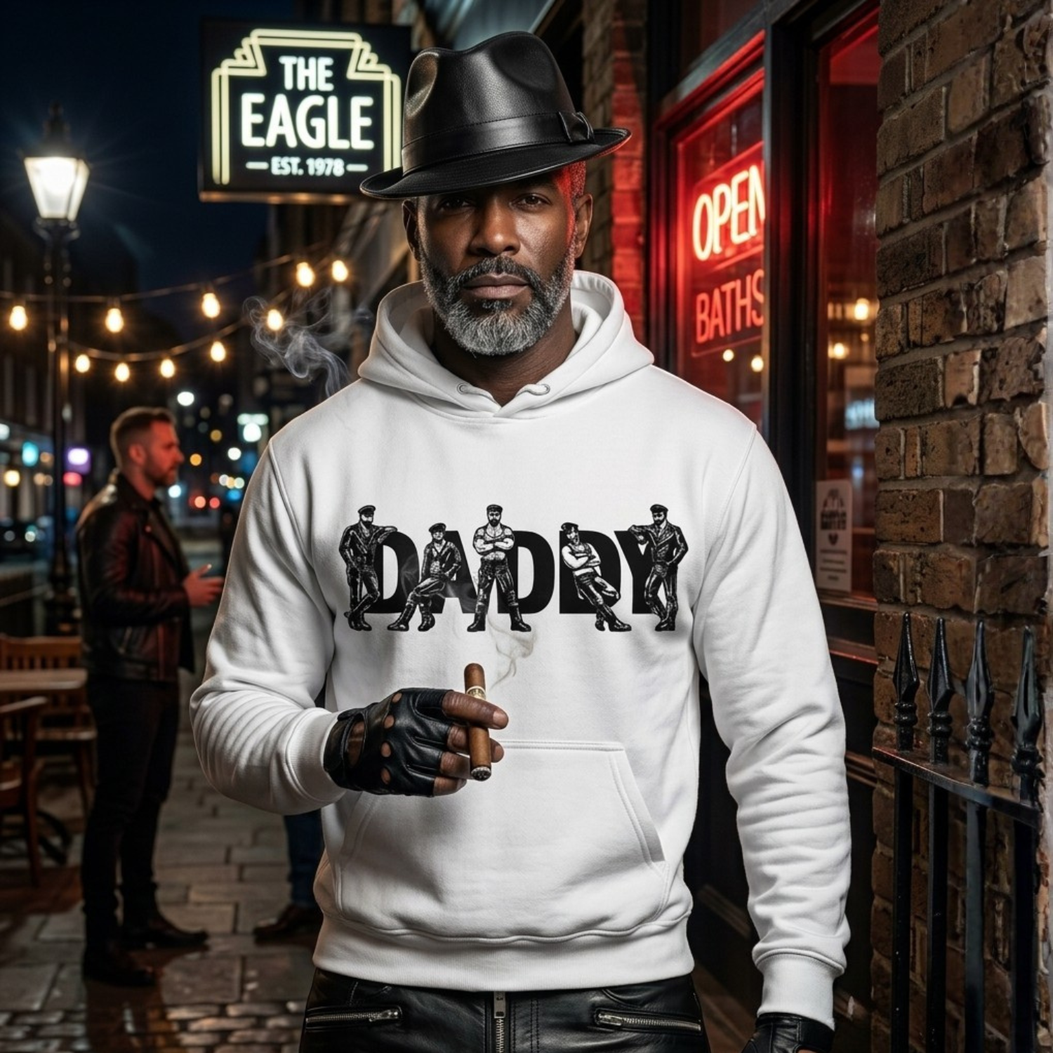 Man wearing a white hoodie with 'DADDY' graphic in an urban setting