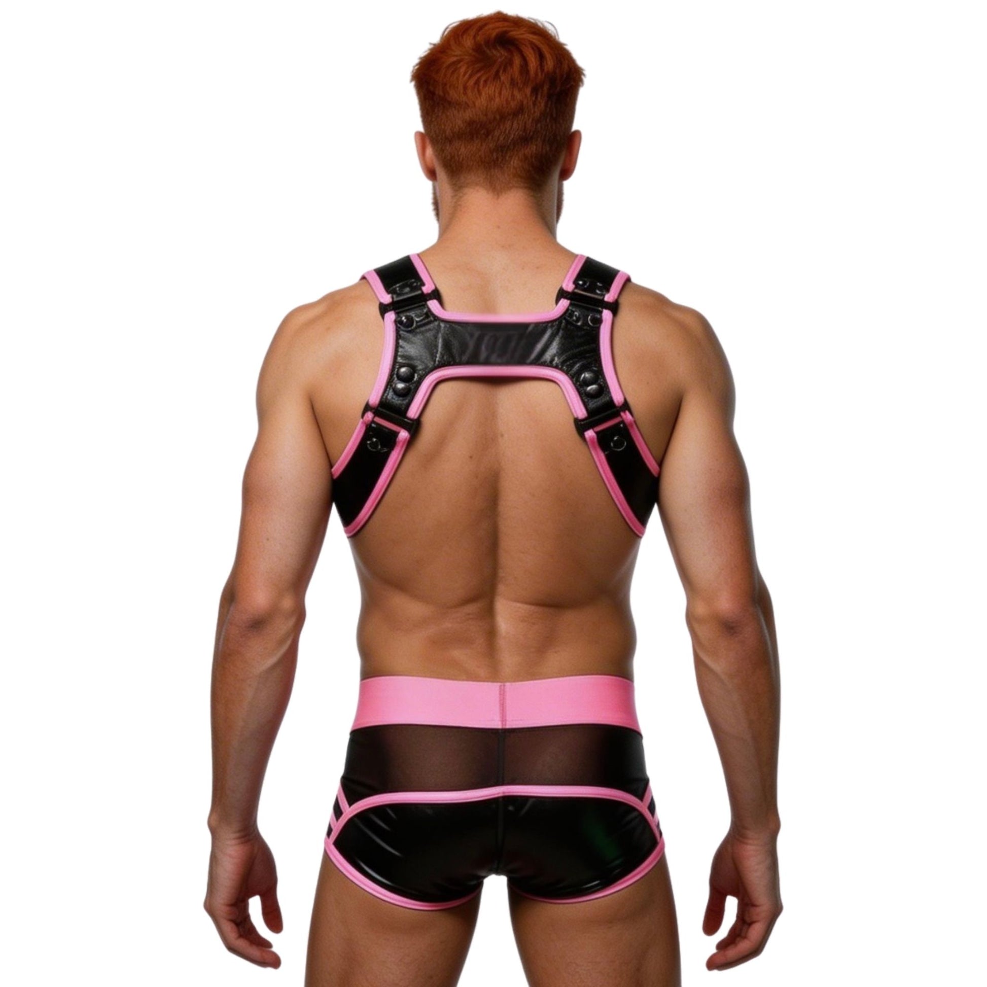 Man wearing a black and pink harness and underwear set on a white background