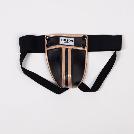 Front detail view of gold metallic trim and black faux leather construction on jockstrap
