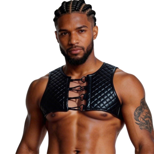 Man wearing a black quilted chest harness on a white background
