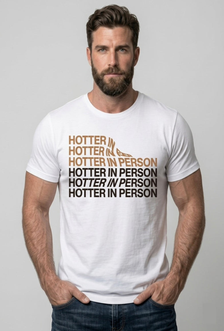 Man wearing a white t-shirt with text 'HOTTER IN PERSON' on a plain background